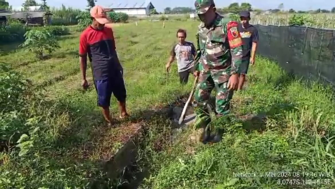 Ciptakan Sanitasi Sehat, Babinsa Koramil 0808/04 Sanankulon Bersama Warga Bergotong-royong Bersihkan Saluran Irigasi